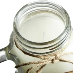 Bougie blanche dans mug en verre avec couvercle - Senteur magnolia patchouli